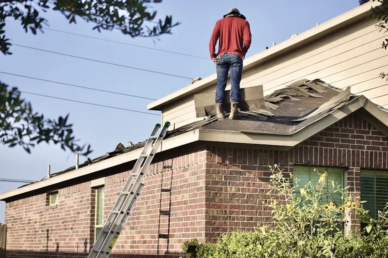 Professional roofer working on a residential roof in Isla Vista